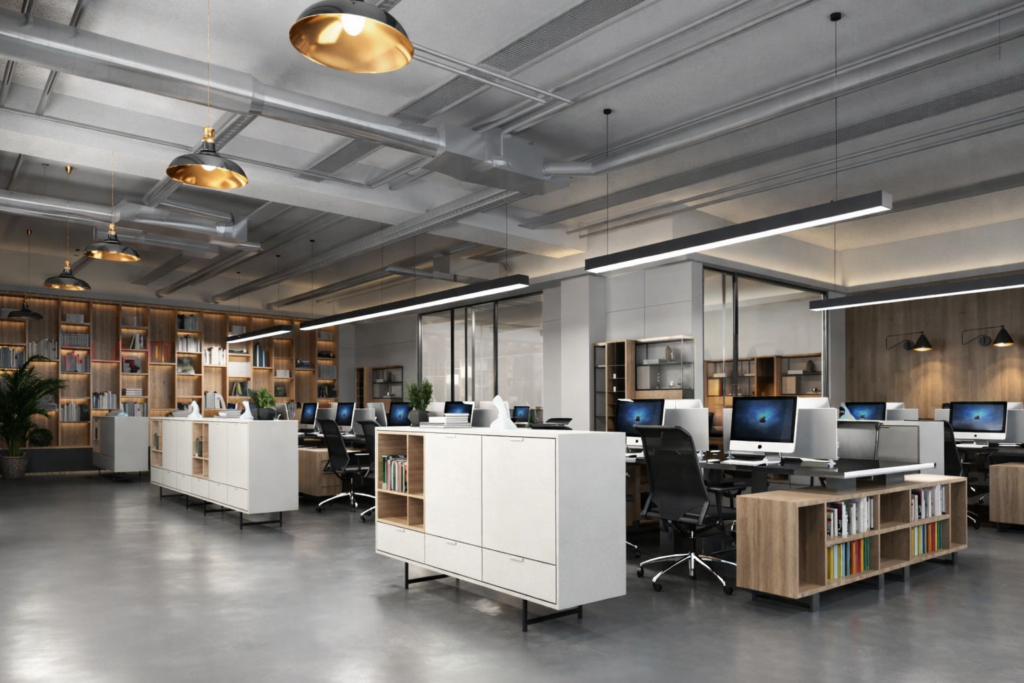 Modern open-plan office interior design in Coimbatore with custom workstations, wooden storage units, and industrial ceiling lighting.